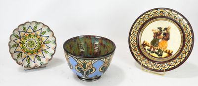 three bowls and a plate on a white surface