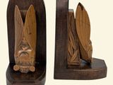 two wooden bookends with carvings of a man and a woman on them