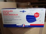 a close up of a box of surgical masks on a table