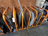 a lot of tennis rackets that are stacked up together