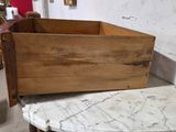a wooden box sitting on top of a marble table