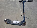 a scooter that is sitting in the middle of a parking lot