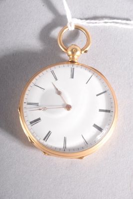 a gold pocket watch hanging from a rope