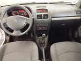 the interior of a small car with a steering wheel and dashboard
