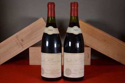 two bottles of wine sitting next to each other on a table