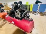 a red air compressor sitting on top of a red tank