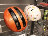 three helmets on display in a store with a price tag