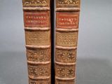paire de livres anciens reliés en cuir, avec des reliures dorées et rouges
