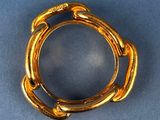 an image of a gold ring on a blue surface