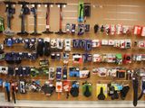 a wall of skis and snowboards on display in a store