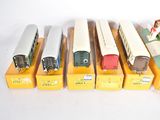seven different train cars sitting in a row on display