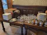 a wooden table with a bunch of plates and glasses on it