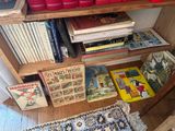 many books that are on the shelves in the room