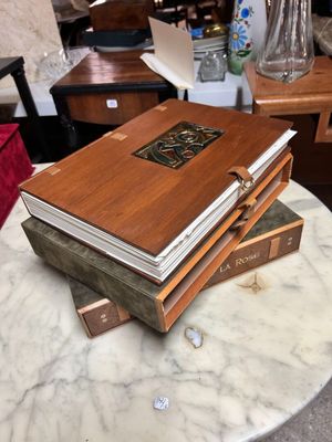 several books stacked on top of each other on a marble table