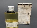 an image of a bottle of perfume sitting next to a box