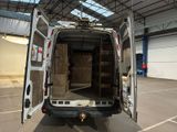 a white van with its doors open in a warehouse