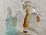 two glass figurines that are sitting on a table