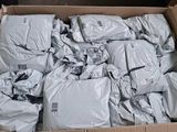 a cardboard box filled with bags of white stuff