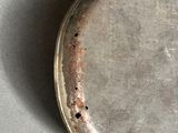 a small metal object with a hole in the middle