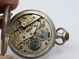 a close up of a pocket watch being held by a person