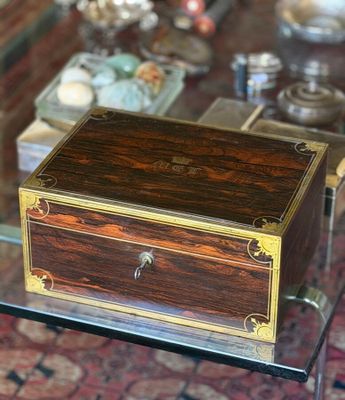 a small wooden box sitting on a glass table