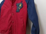 jacket hanging on a wall in a room with a white wall