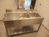 two sinks in the kitchen with a faucet on the counter