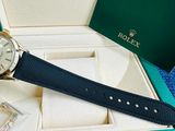 the rolex watch is in the box with the watch in it