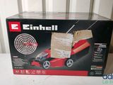 an image of a box with a red lawn mower inside of it
