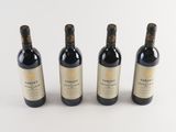three bottles of wine sitting next to each other on a white surface