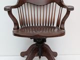 a wooden chair that is sitting on a pedestal