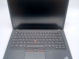 the laptop is open on a white surface with a black keyboard