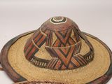 two hats are sitting on top of a white table