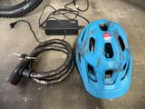 a blue helmet and a cable connected to a bicycle