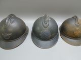 three helmets that are sitting on a table