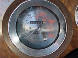 a close up of a gauge on a wooden table