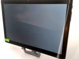 a small monitor on a stand on a white surface