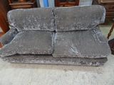 a couch that is sitting on the floor in front of a dresser