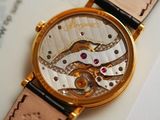 a close up of a watch on a piece of paper