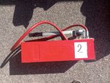 a red box with a number on it sitting on the ground