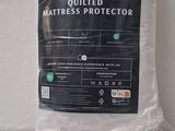 the mattress protector is in a plastic bag on a white surface