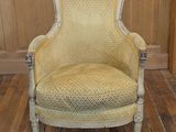 a yellow chair that is sitting on a wooden floor