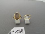 two rings and a ring on a table with a price tag