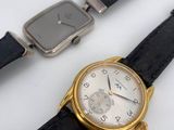 two watches sitting next to each other on a table