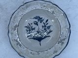 a blue and white plate with a bird on it