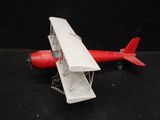 a toy airplane that is sitting on a black surface