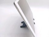 a tablet computer sitting on a stand on a white surface
