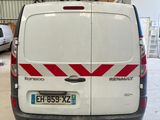 a white van with red stripes parked in a garage