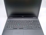 a laptop with a black keyboard sitting on a white surface