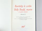 an open book with red writing on it sitting on top of a table